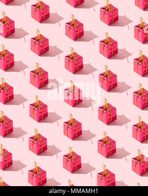 Small gift boxes organized over pink background Stock Photo