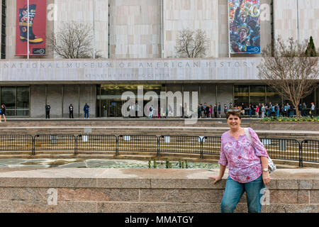 A woman stands in front of the American History Museum Stock Photo