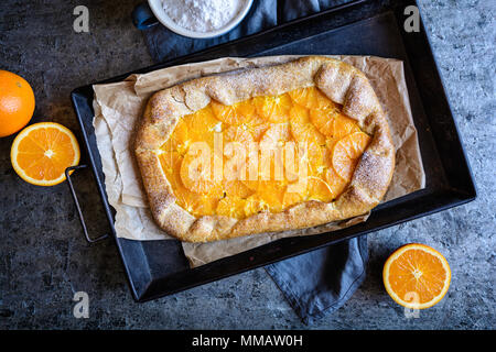 Homemade whole meal Galette with orange slices Stock Photo