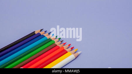 Color Pencils on violet Background for Projects and Announcements. Stock Photo