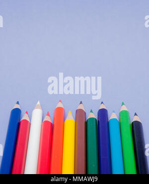 Color Pencils on violet Background for Projects and Announcements. Stock Photo