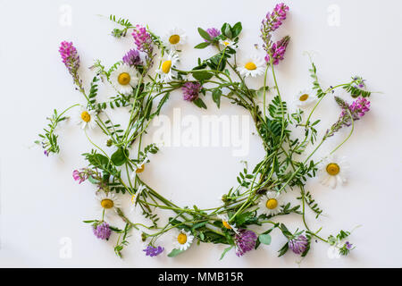 Wreath flat lay of field flowers on white background Stock Photo