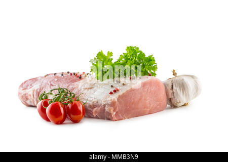 Pork loin fillet parsley herb tomatoes garlic salt and spices isolated on white background. Stock Photo