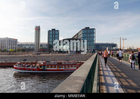 City view of Berlin, with people crossing a bridge over the river, with central station in the background Stock Photo