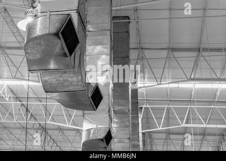 Air blower pipe to cooling air flow and ventilation of large industry construction storehouse or factory. Stock Photo