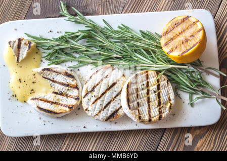 Grilled Camembert cheese with rosemary Stock Photo