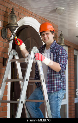 Male Electrician Standing On Stepladder Repairing Light Stock Photo - Alamy