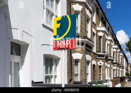 A sign on a property in a row of terraced houses, sold by Foxtons estate agents Stock Photo