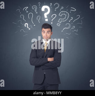 Young businessman with white question marks above his head Stock Photo
