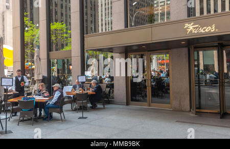 Diners enjoy the warm spring day as they dine al fresco at Del Frisco's restaurant in Midtown Manhattan in New York on Monday, May 7, 2018. Del Frisco's Restaurant Group reported first-quarter earnings that missed analysts' expectations on the same day that the Texas-based company announced it was buying the Barteca Restaurant Group, the operator of Barcelona Wine Bar and Bartaco in a cash deal of $325 million. (Â© Richard B. Levine) Stock Photo