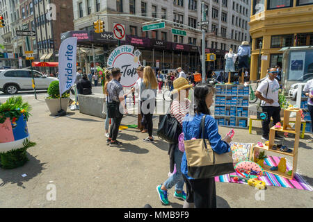 Passer by visit a Stride Rite branding event in Union Square in New