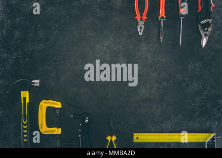 top view of various mechanical tools for work on dark tabletop Stock Photo
