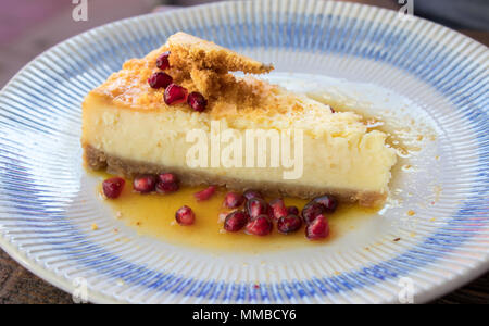 Delicious cheesecake served with pomegranate seeds. Stock Photo