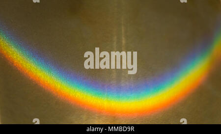 An anstract macro shot of sunlight passing through plastic and making a rainbow of colours. Stock Photo