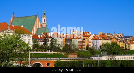 Warsaw, Mazovia / Poland - 2018/04/22: Panoramic view of historic quarter of Warsaw with Royal Castle and old town tenements seen from the Vistula riv Stock Photo