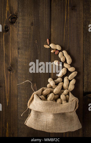 Peanuts in Shells on Wooden Background. Rustic Style. Stock Photo