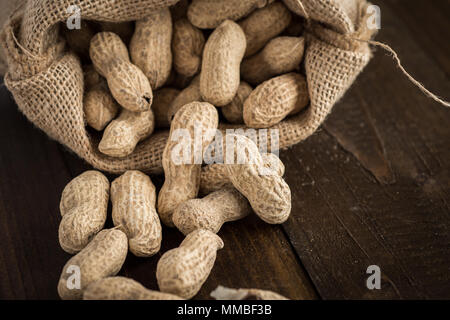 Peanuts in Shells on Wooden Background. Rustic Style. Stock Photo