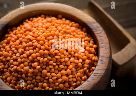 Organic Red Lentils in Bowl on Wooden Table Stock Photo