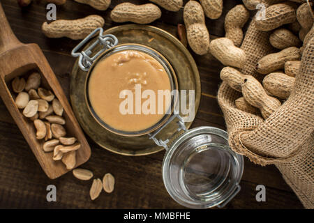 Homemade Peanut Butter in Glass Jar. Healthy Breakfast. Stock Photo