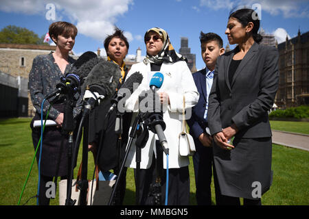 Fatima Boudchar (centre) and her son Abderrahim Belhaj, 14, with lawyers Cori Crider (far left) and Sapna Malik (far right) from Reprieve make a statement outside the Houses of Parliament in London. The UK Government has reached a &Ograve;full and final settlement&Oacute; to former Libyan dissident Abdul Hakim Belhaj, Attorney General Jeremy Wright has told the House of Commons. Stock Photo
