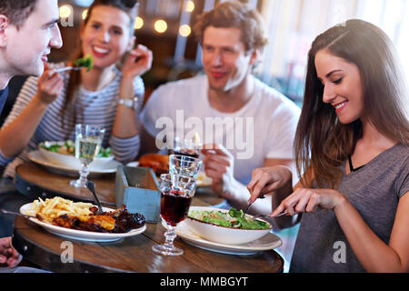Group Of Friends Enjoying Meal In Restaurant Stock Photo