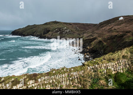 Cot Valley, St Just. View down from the cliff path over the bay and waves crashing against the cliffs. A stormy day. Stock Photo