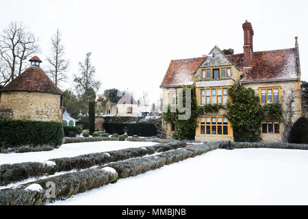 Historic 17th century manor house with tall chimneys, a hotel with snow covered grounds in winter. Stock Photo