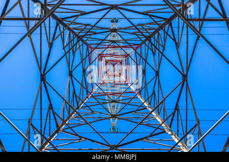 Bottom view of the metallic and symmetrical structure of a high voltage electric pylon, France. Stock Photo