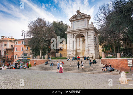 Rome, Italy, march 2017: unrecognizable people sitting on the steps under the monumental marble fountain in the historic Piazza Trilussa in the famous Stock Photo