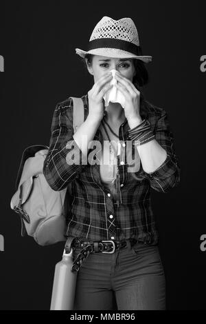 Searching for inspiring places. ill woman hiker in a plaid shirt blowing nose isolated on Stock Photo