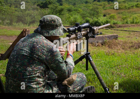 A Philippine Marine fires the M110 Semi-Automatic Sniper System during a live-fire range with U.S. Reconnaissance Marines from the Maritime Raid Force, 31st Marine Expeditionary Unit, during exercise KAMANDAG at Fort Ramon Magsaysay, Philippines, October 6, 2017. Elements of the 31st MEU are currently supporting the 3rd Marine Expeditionary Brigade, participating in exercise KAMANDAG.  Bilateral exercises such as KAMANDAG increase the ability of the United States and the Philippines to rapidly respond and work together during real world terrorist and humanitarian crises, in order to accomplish Stock Photo