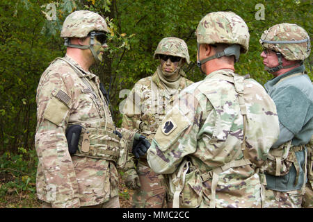 Sergeant training Ukrainian soldiers on a shooting range outdoor. Army ...