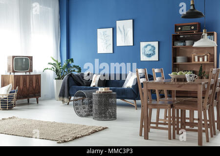 Wooden dining table in spacious retro style lounge Stock Photo