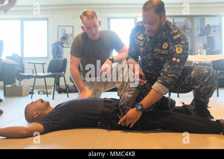 (170916-M-ZZ999-012) U.S 5TH FLEET AREA OF OPERATIONS (Sept. 16, 2017) – Members of the Kuwaiti Ministry of Interior Explosive Ordnance Team provide first responder care and a primary exam to a simulated casualty during the final trauma exercise during a medical exchange with the Kuwaiti Ministry of Interior explosive ordnance team in Kuwait. The 15th MEU is deployed with the America Amphibious Ready Group in order to maintain regional security in the U.S. 5th Fleet area of operations. (Courtesy photo by Hospital Corpsman 1st Class Tonya Jury) Stock Photo