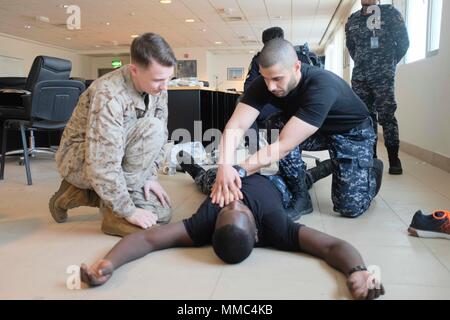 (170916-M-ZZ999-015) U.S 5TH FLEET AREA OF OPERATIONS (Sept. 16, 2017) – Members of the Kuwaiti Ministry of Interior Explosive Ordnance Team provide first responder care and a primary exam to a simulated casualty during the final trauma exercise during a medical exchange with the Kuwaiti Ministry of Interior explosive ordnance team in Kuwait. The 15th MEU is deployed with the America Amphibious Ready Group in order to maintain regional security in the U.S. 5th Fleet area of operations. (Courtesy photo by Hospital Corpsman 1st Class Tonya Jury) Stock Photo