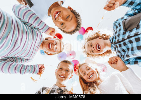 Group of happy children holding balloons and having fun Stock Photo