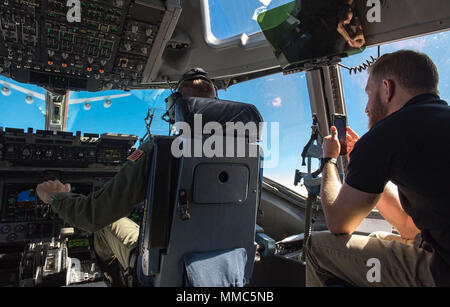 Jeffrey Earnhardt, Monster Energy NASCAR Cup Series driver, observes and records 3d Airlift Squadron pilots flying a C-17 Globemaster III into position for air refueling Sept. 28, 2017, out of Dover Air Force Base, Del. Earnhardt observed the Globemaster III being refueled by KC-135T Stratotankers from the 127th Wing, Selfridge Air National Guard Base, Mich. (U.S. Air Force photo by Roland Balik) Stock Photo