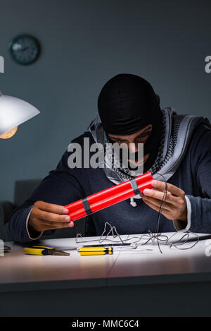 Terrorist bomber preparing dynamite bomb Stock Photo