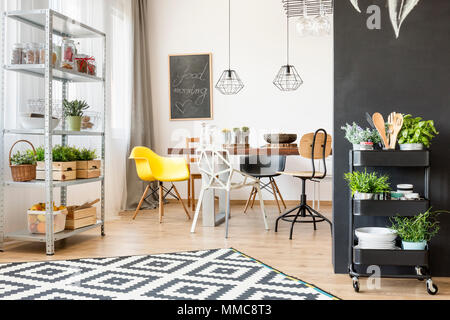 Open dining room with table, chair and industrial pendant lamp Stock Photo