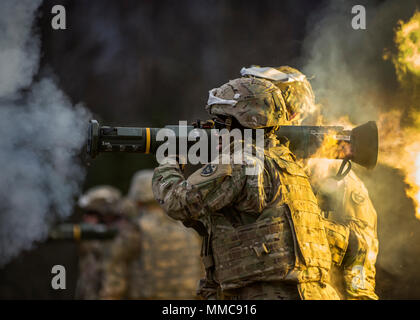 Army Tracer Rockets Army Staff Sgt. Kiatwain Andres observes as Staff Sgt. David Riley ...