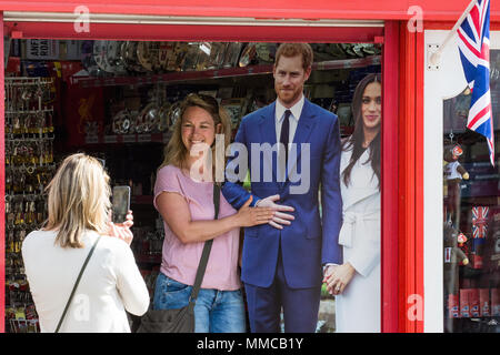 Windsor, UK. 10th May, 2018. Tourists take pictures with cardboard cutouts of Prince Harry and Meghan Markle in advance of the royal wedding at Windsor Castle on 19th May. Credit: Mark Kerrison/Alamy Live News Stock Photo