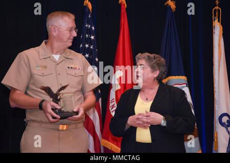171012-N-SQ432-082 WASHINGTON (Oct. 12, 2017) – The Principal Civilian Deputy Assistant Secretary of the Navy Research, Development and Acquisitions, Allison F. Stiller, right, presents Vice Adm. David Lewis with the Rear Adm. Wayne E. Meyer Memorial Award at the 2017 The Department of the Navy Acquisition Excellence Awards on Oct 12. The Department of the Navy Acquisition Excellence Awards were established by the Secretary of the Navy in 2008 to recognize military and civil service individuals and teams who have made the most outstanding contributions to enhancing competition and innovation t Stock Photo