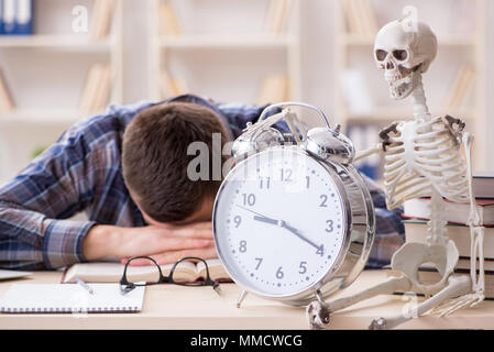 Student and skeleton preparing for school exams Stock Photo