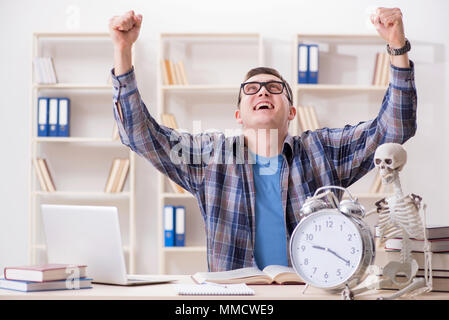 Student and skeleton preparing for school exams Stock Photo