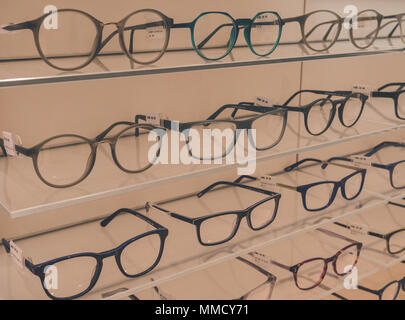 Rimini, Italy, March 21, 2018 many glasses are exposed on glass shelves to glasses store Stock Photo