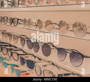 Rimini, Italy, March 21, 2018 many glasses are exposed on glass shelves to glasses store Stock Photo