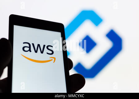 MOSCOW, RUSSIA - MAY 9, 2018: Smartphone in hand with Amazon Web Services (AWS) logo. Roskomnadzor (RKN) emblem on background. Millions of IP was bloc Stock Photo