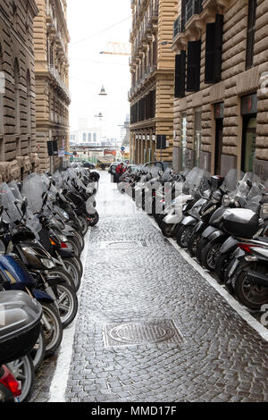 Rows of motor scooters parked in a Naples side street in Italy Stock Photo