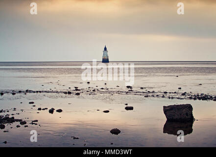 Plover Scar lighthouse at late evening, bathed in luminescent back-light Stock Photo