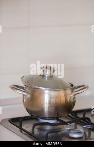 the pan is on the stove with the gas turned on Stock Photo